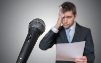Nervous man is afraid of public speech and sweating. Microphone Public Speaking – Speaking Under Pressure